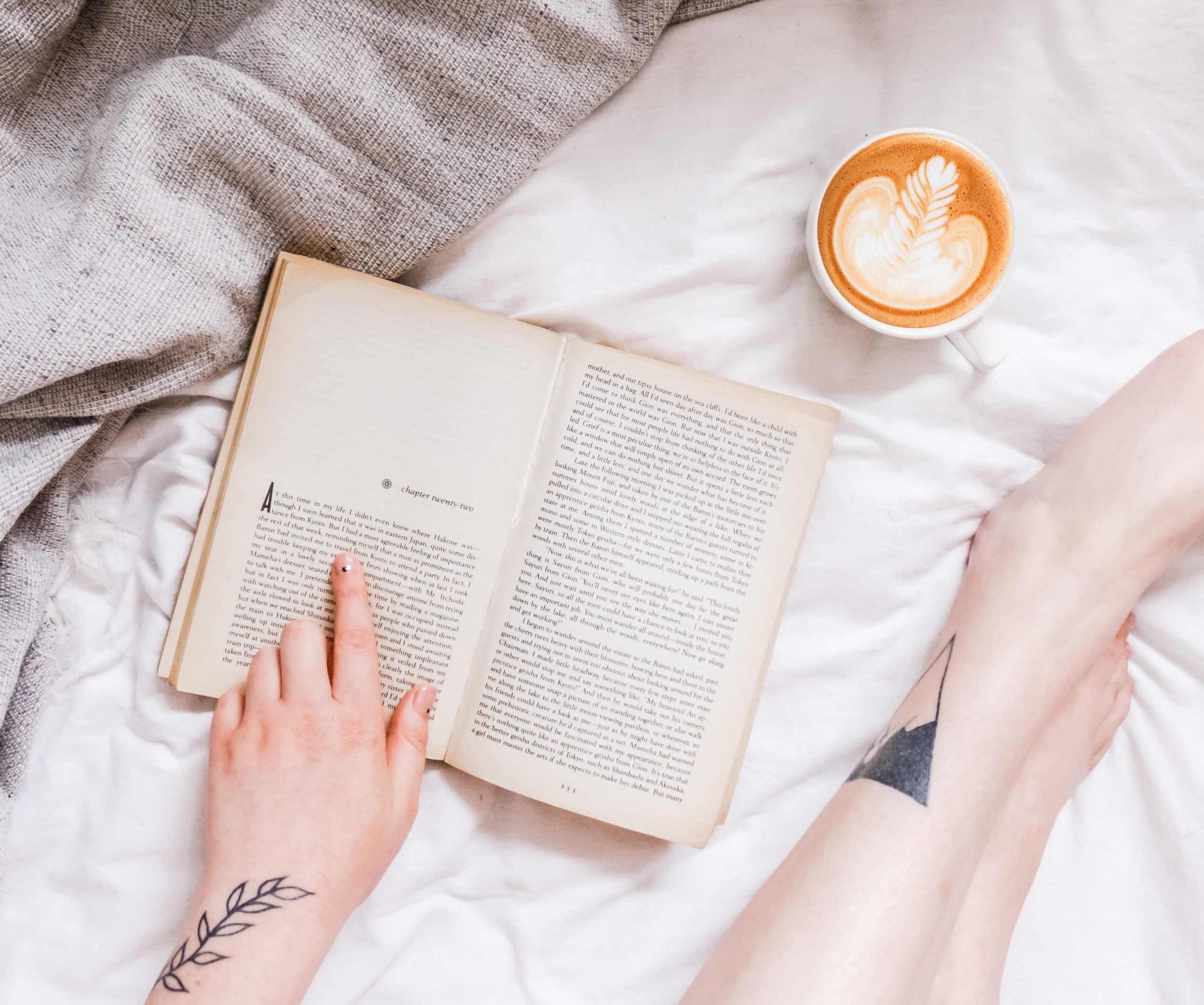Woman reading a book with a cup of coffee